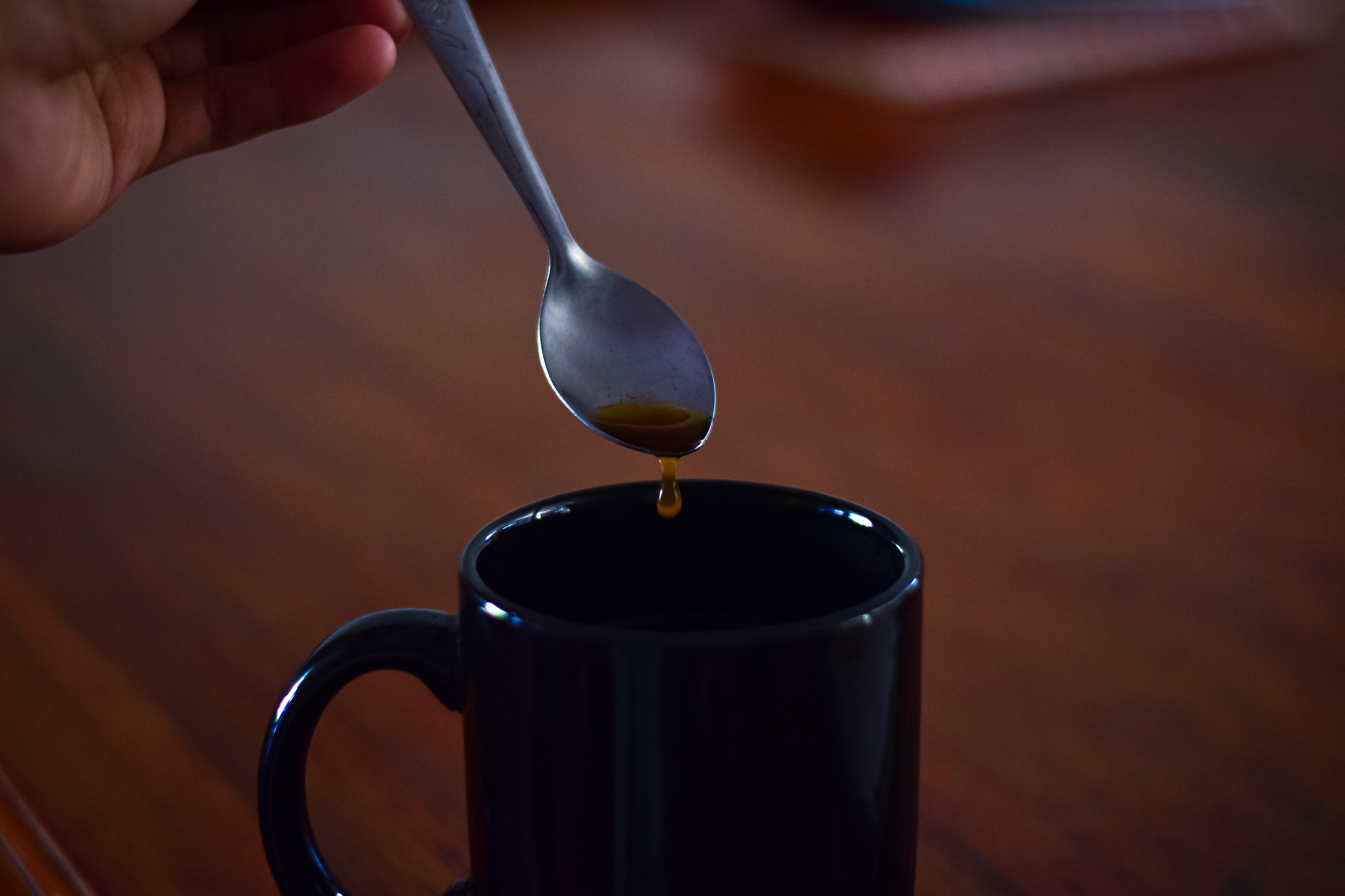 close-up-hand-pouring-coffee-cup.jpg